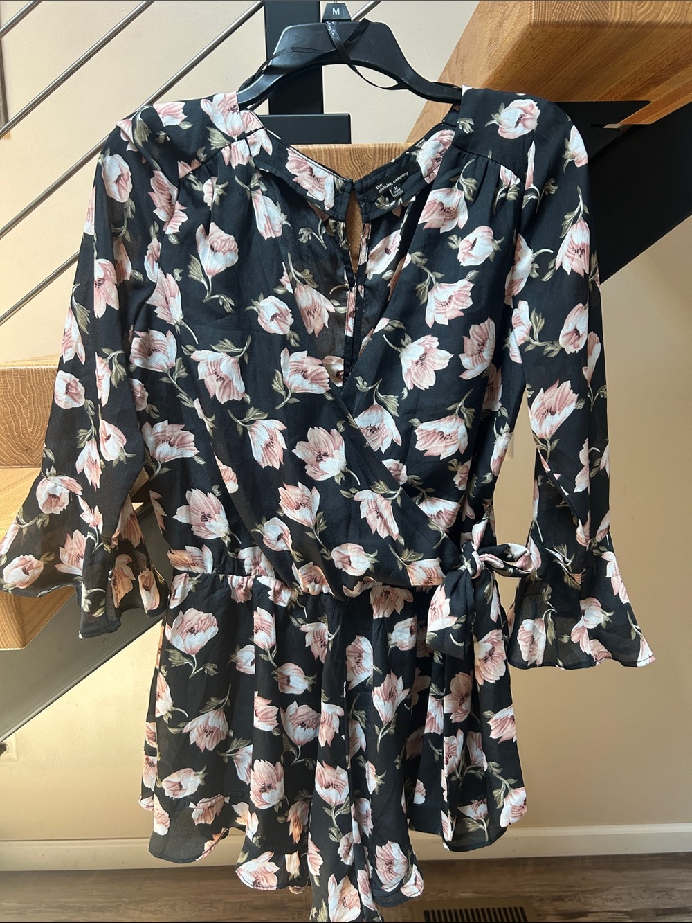 the clothing company Black Floral Wrap Romper with Blush Blooms